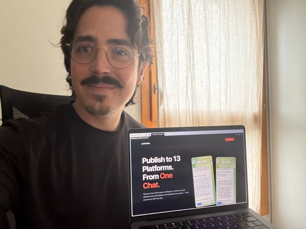 Adrien next to a laptop showing the Postclaw landing page