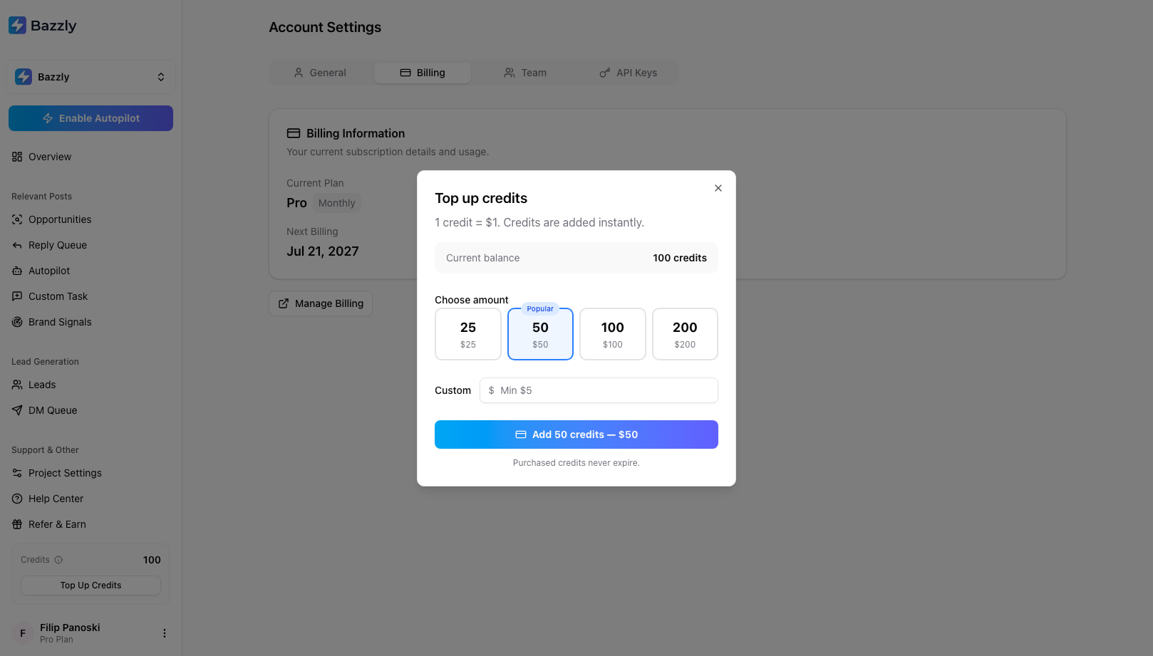 The Top up credits modal showing 1 credit equals one dollar, preset amounts of 25, 50, 100 and 200, and a custom amount field
